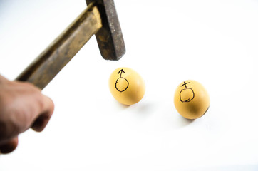 Symbols of male and female. painted on chicken eggs. Point to floor. Man and woman in front,...
