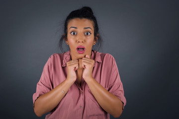 Human face expressions and emotions. Portrait of young desperate woman looking panic, holding her...