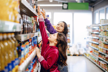 Mother with a daughter. Family in a supermarket