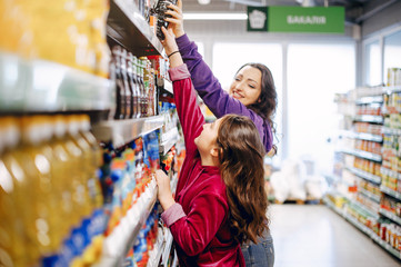 Mother with a daughter. Family in a supermarket