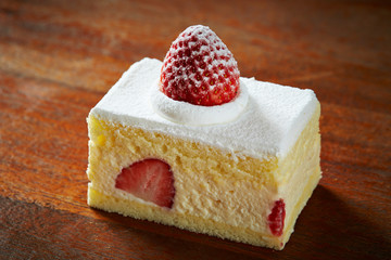 Strawberry shortcake on wooden background 