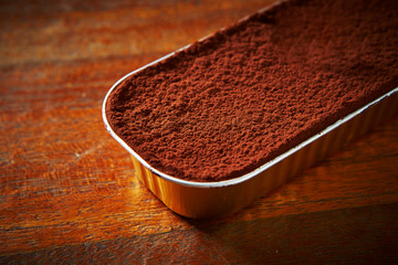 Tiramisu cake on wooden background 