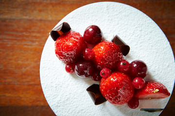 Berry cake on wooden background 