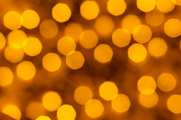 Obraz premium Holiday illumination of sparkling brown and yellow bokeh background