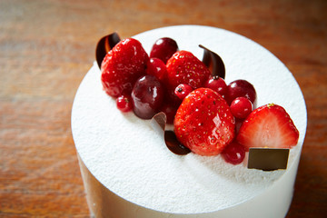 Berry cake on wooden background 