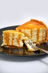Sweet dessert from air curd cheesecake poured with caramel
