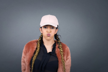 Beautiful young woman puffing cheeks with funny face. Mouth inflated with air, crazy expression.