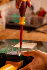 luthier working on repairing a guitar