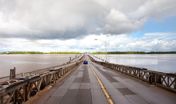 View of the pontoon bridge over the Demerara harbour bridge on a clear Sunny day before a thunderstorm, Guyana. World tourism, attractions, landscape.