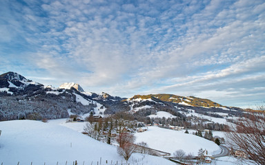 Fototapeta na wymiar Idyllic winter landscape of Swiss mountains. Region of Gruyere, province of Fribourg, Switzerland