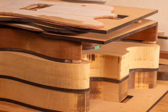 guitar bodies stacked in production in a luthiery