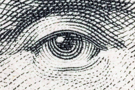 Macro close up photograph of Abraham Lincoln eye on the US five dollar bill. 