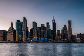 Fototapeta na wymiar Sunset Over East River Lower Manhattan Skyline View From Brooklyn Bridge Park