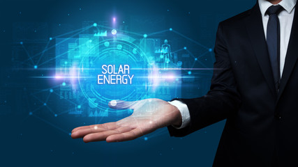 Man hand holding SOLAR ENERGY inscription, technology concept