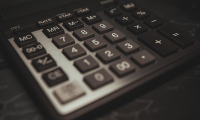 Obraz premium Calculator is placed on the desk in the office on dark background
