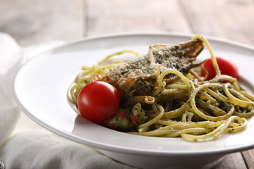 The concept of Italian cuisine. Pasta with seafood and tomatoes on a wood background
