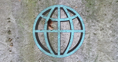 On concrete wall depicts the symbol of the terrestrial globe, texture and background.