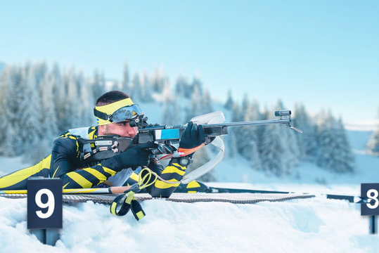 Biathlete shoots targets with a rifle. Concept of concentration and precision in the race against time.
