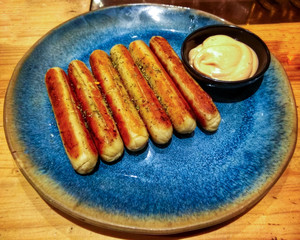 Sausage roasted into a blue plate