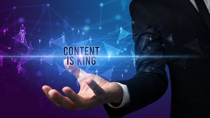 Elegant hand holding CONTENT IS KING inscription, social networking concept