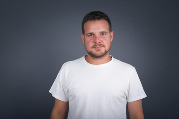 Obraz premium Horizontal portrait of pleasant-looking Caucasian male wearing casual clothes looking happily to the camera.