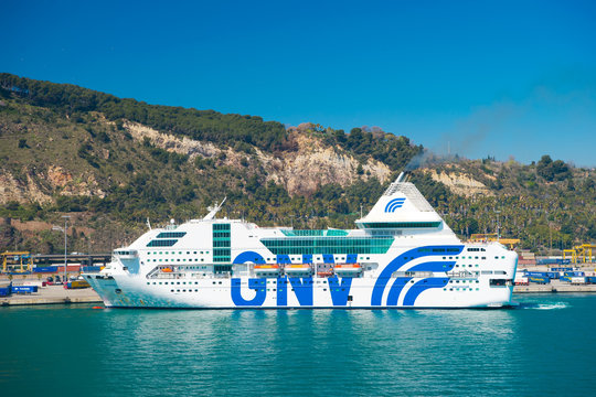 Barcelona, Spain - March 30, 2016: cruise ship GNV Rhapsody Genova in sea on mountain landscape. Cruise destination and trip. Summer vacation and holiday. Wanderlust and discovery. Travelling by sea