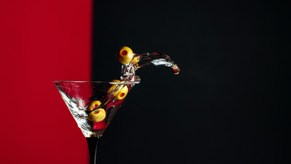 Martini with green olives splash.