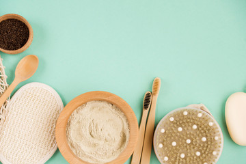 Cosmetic bath salt, grape gomaj for the face, coffee scrub for the body on a mint background. Spa...