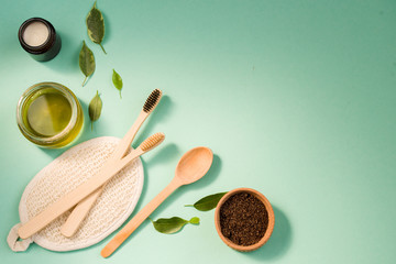 Cosmetic bath salt, grape gomaj for the face, coffee scrub for the body on a mint background. Spa...