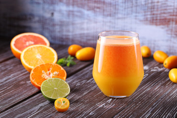 Freshly squeezed orange juice from red and yellow oranges, in one glass, a tasty and healthy drink, rich in vitamins.