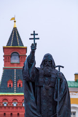 Fototapeta premium Moscow, Russia - March 22, 2019: Monument to the Patriarch Hermogenes of Moscow. Blurred Arsenal tower of the Kremlin on the background.