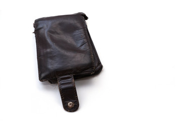 An old, worn, scratched and torn wallet made of genuine brown leather. The wallet is isolated on a white background. Poverty and need Concept. Copy space.