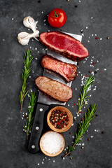 Three pieces of meat grilled over a meat knife. Three types of frying meat, rare, medium, well done...