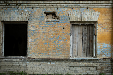 Fototapeta na wymiar Part of abandoned building with two broken windows