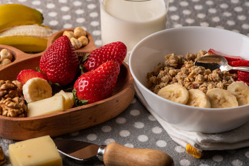 fresh strawberries and  nuts on a wooden plate