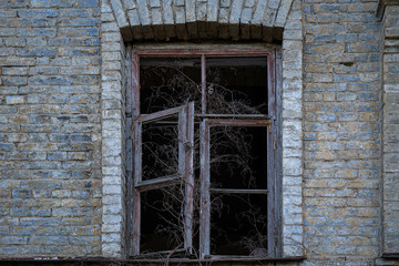 Fototapeta na wymiar Part of abandoned building with broken window