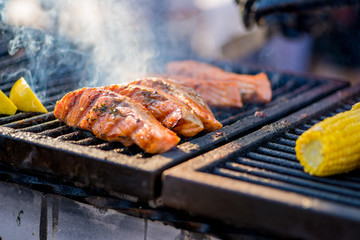 BBQ fish steaks. Pieces of salmon are fried over an open fire. Fire and smoke roll over pieces of fish
