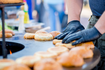 cook hands in gloves grill burger buns