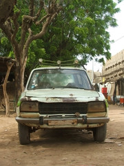Old car in the street of Djenne, Mali