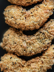 food, fried shrimp breaded with spices on a black background