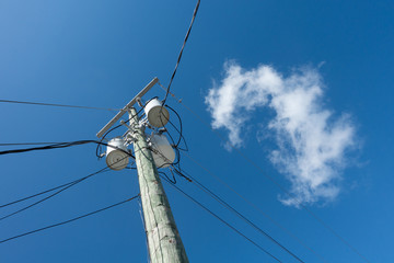 high voltage power lines against blue sky