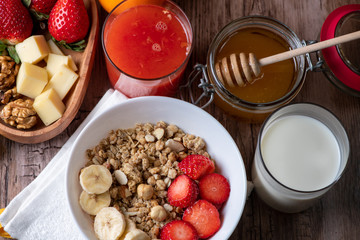 healthy breakfast with milk, muesli, honey and strawberries 