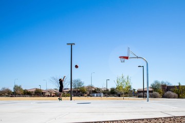 Boy Shooting Basketball into Hoop