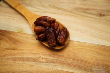 Some dried dates on a wooden board