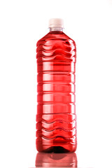 Red drink in plastic bottle on white background