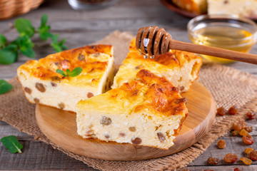 Cottage cheese casserole with raisins and honey, close up