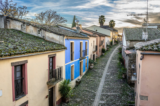 Sunset view at a medieval age town in Extremadura, Spain. A diminishing perspective view of the street and houses of the historical Granadilla town
