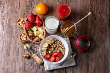 healthy breakfast with milk, muesli, honey and strawberries 