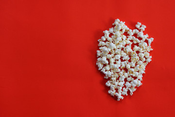 Popcorn frame, flying popcorn isolated on red background with copy space, movie poster concept