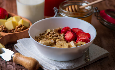 healthy breakfast with milk, muesli, honey and strawberries 